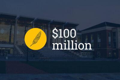 Civic building with the words "$100 million" and a yellow icon of a feather on top.